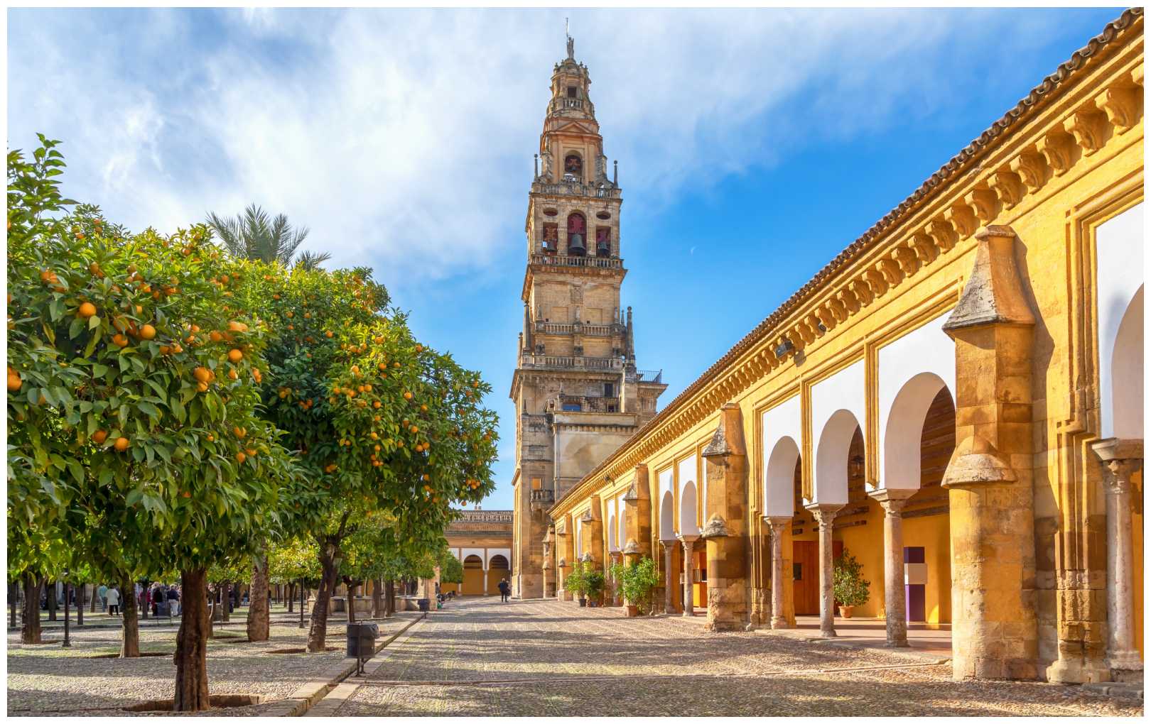 Cordoba, Spain. View of Torre Campanario - historical bell tower and courtyard planted with orange trees