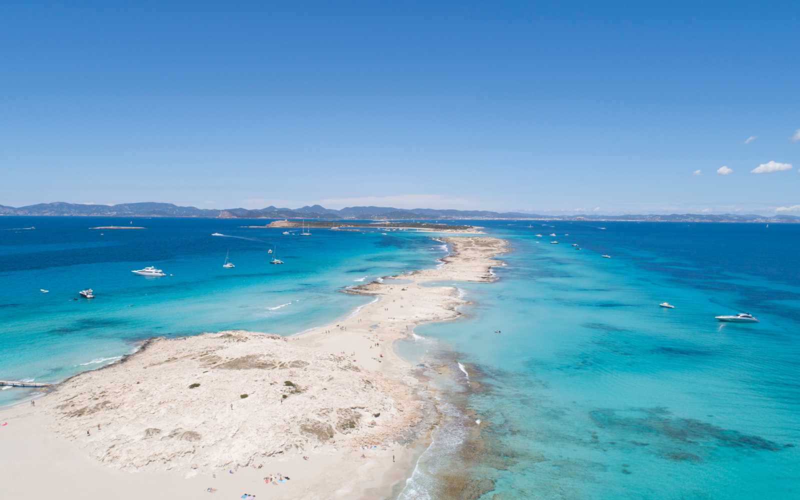 illetas, formentera beach seen from drone with turquoise and crystalline sea and Ibiza in the background